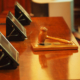 A picture of a judge's gavel resting on a courtroom table